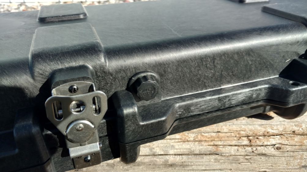 A black rifle case featuring a lock on its top, suggesting secure storage.