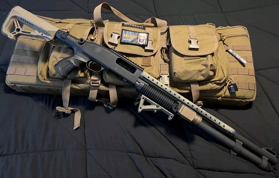A shotgun resting on top of a brown bag, showcasing the firearm's barrel and stock against the bag's texture.