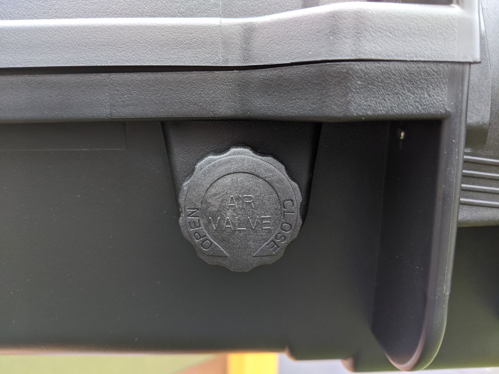 Close-up of the pressure valve on the side of a black gun case