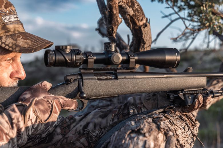 A hunter aiming his Bolt-action Remington 700 rifle 