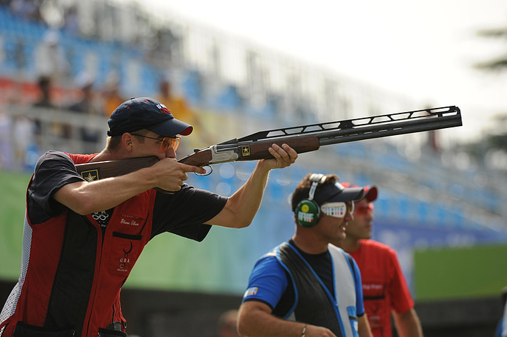 man holding shotgun at a shooting competition