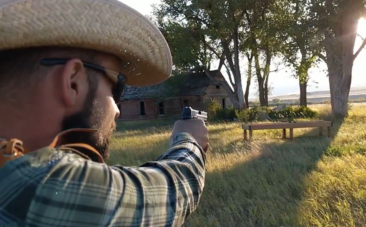 A shooter aiming a handgun showing how to handle a gun