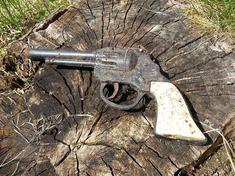 silver-and-black-revolver-on-brown-wooden-surface